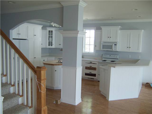 Painted cabinets - Flat panel doors and drawer fronts - Standard overlay style - Solid surface countertops